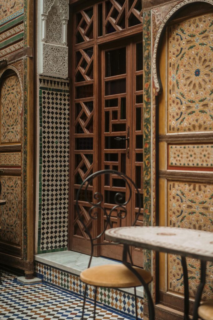 Intricate Moroccan architecture featuring patterned tiles and carved wooden doors in Fes.