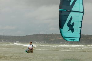 A Man Kitesurfing on the Sea