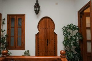 Cozy Moroccan interior featuring a distinct wooden door and lush plants.