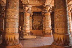 Intricate Egyptian-themed columns inside a temple-like structure in Ouarzazate, Morocco.